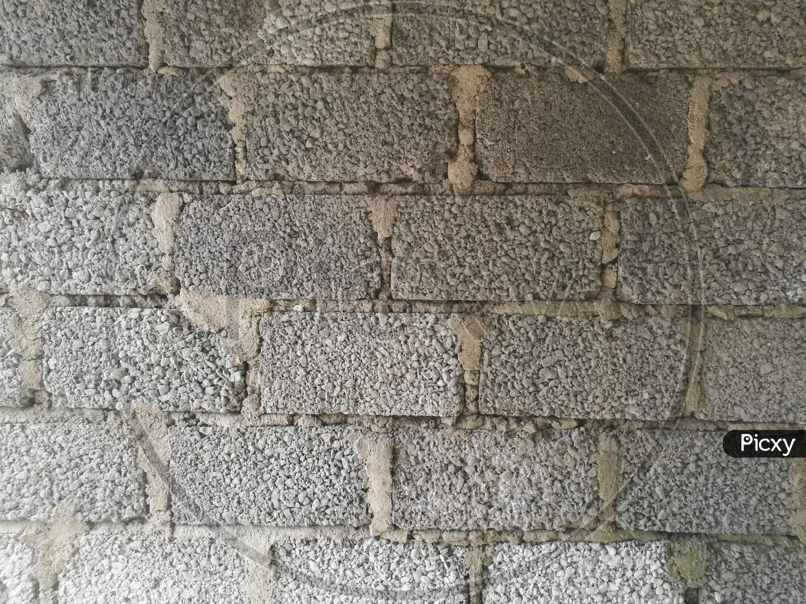A Wall Made Of Cement Blocks And Concrete Like Texture.