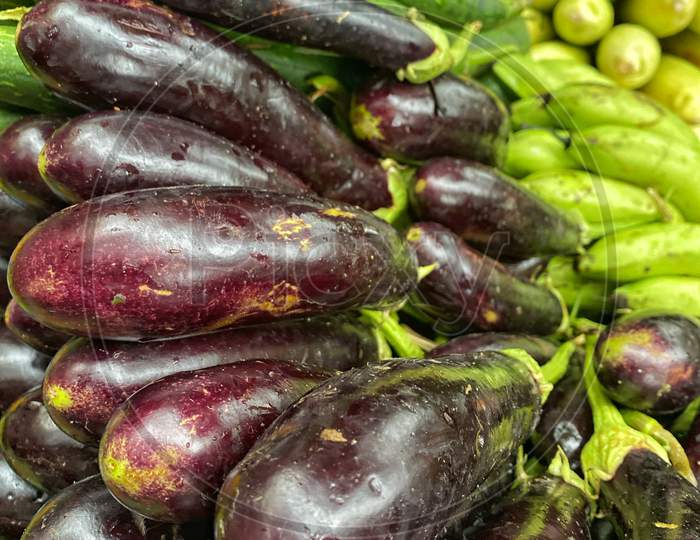 Farm Fresh Eggplant Stacked On Top Of Each Other In A Market