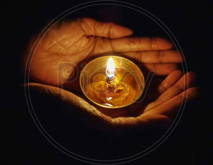 Woman holding oil lamp or diya for traditional fastival