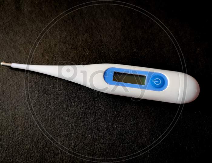 Digital Thermometer For Measuring Temperature. Isolated On Black Background.