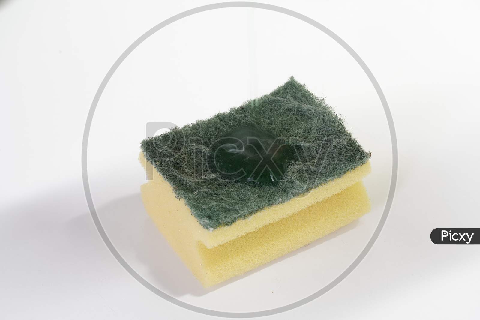 Scouring Pad On White Table With Dish Soap On Top