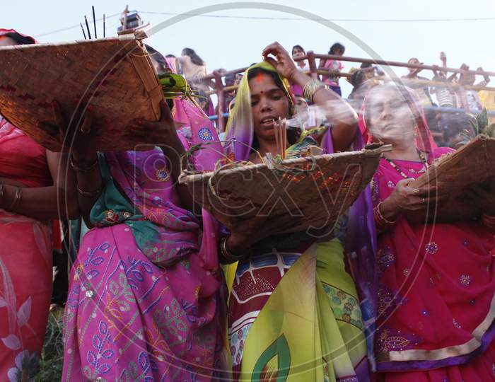 A group of Hindu women perfoming chhath puja on the bank of powai lake mumbai
