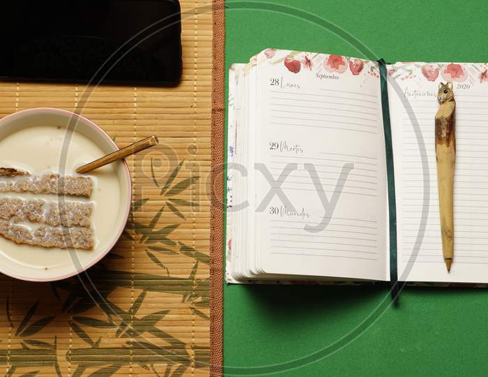 Concept Of Work Dough At Home In The Morning With Breakfast Notebook Pen And Smart Phone. Flat Lay.