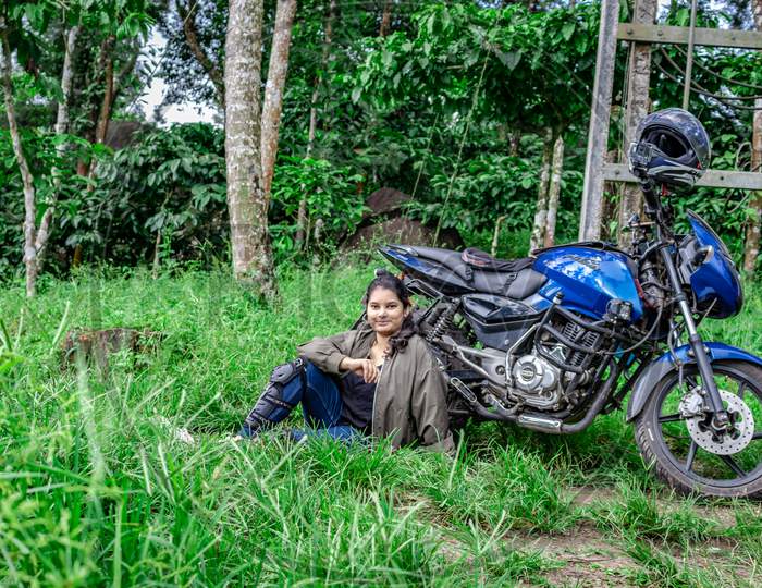 Girl Solo Rider Sitting At Remote Trails With Motorcycle And Helmet From Different Angle