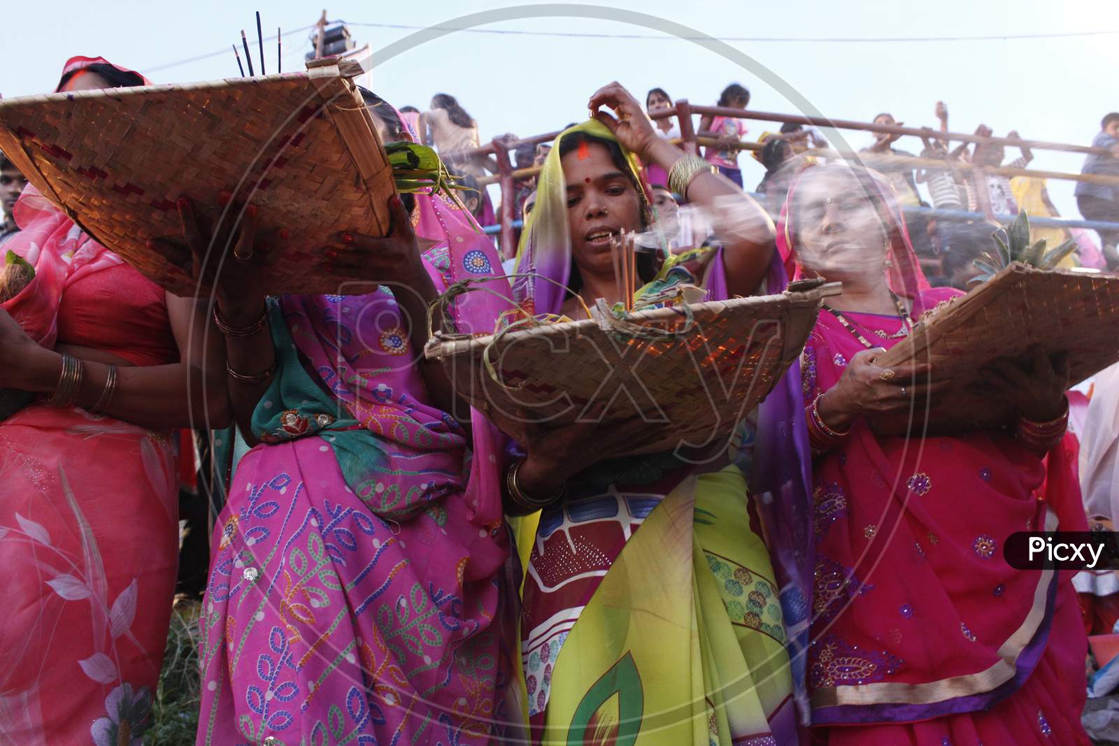A group of Hindu women perfoming chhath puja on the bank of powai lake mumbai