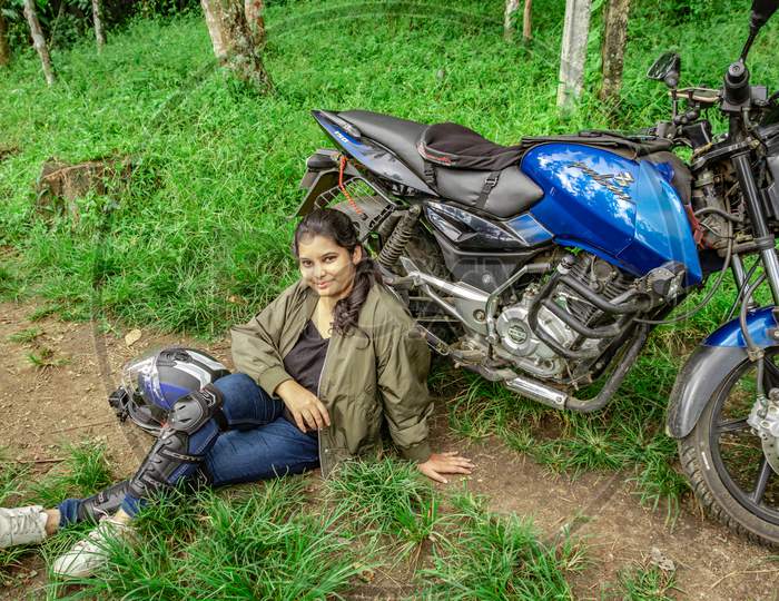 Girl Solo Rider Sitting At Remote Trails With Motorcycle And Helmet From Different Angle