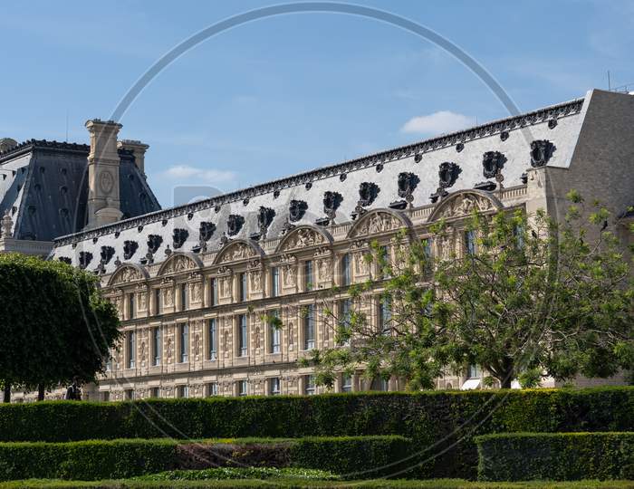 Close-Up Of Louvre Palace With Park, Pavillon De Marsan, Lawn And Flowers At Hot Sunny Day. Paris - France, 31. May 2019