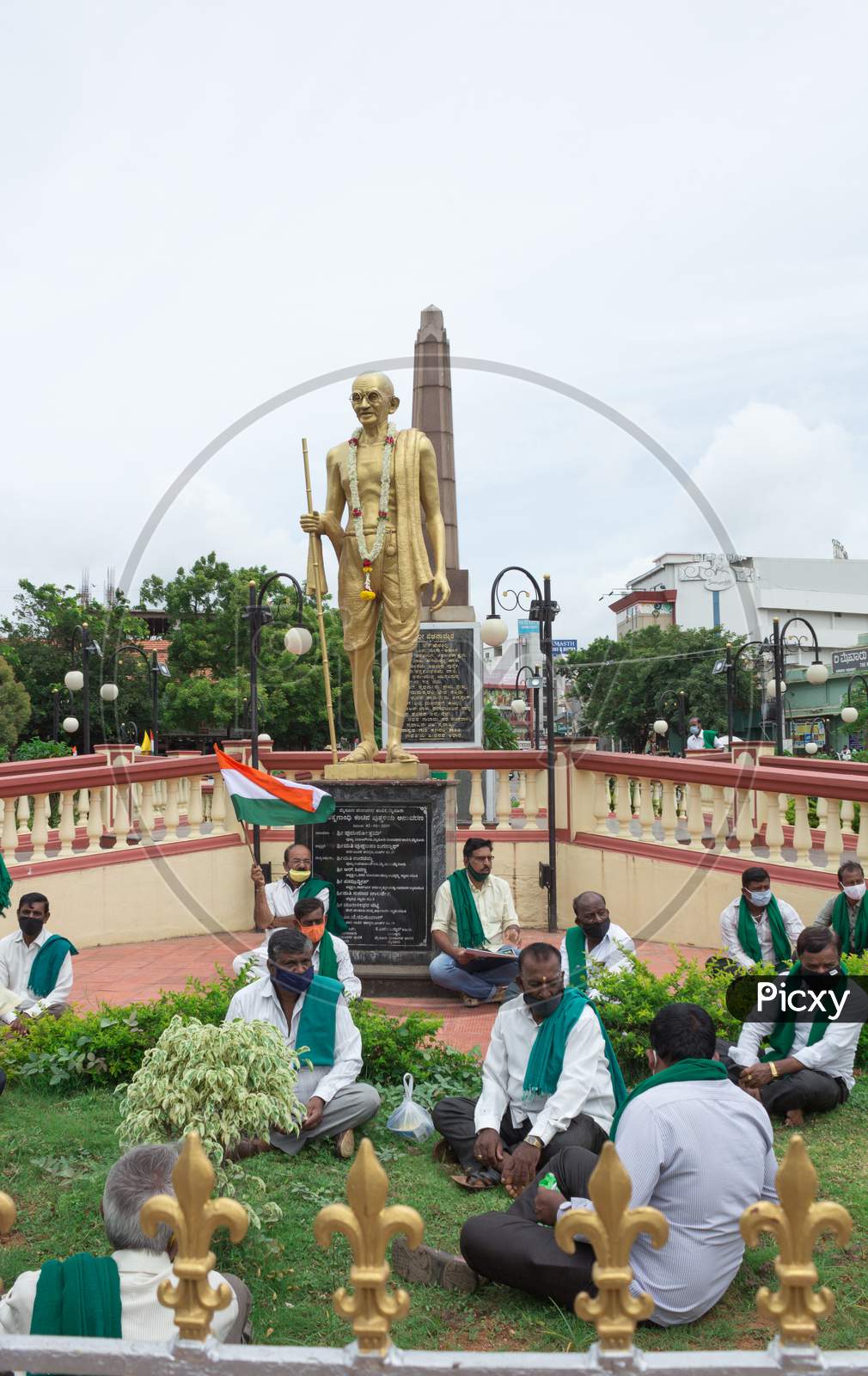Farmers sitting under Mahatma Gandhi statue at Mysore/Karnataka/India.