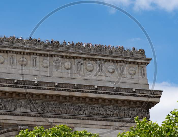Close-Up Of Arc De Triomphe Covered With Tourists. Paris - France, 31. May 2019