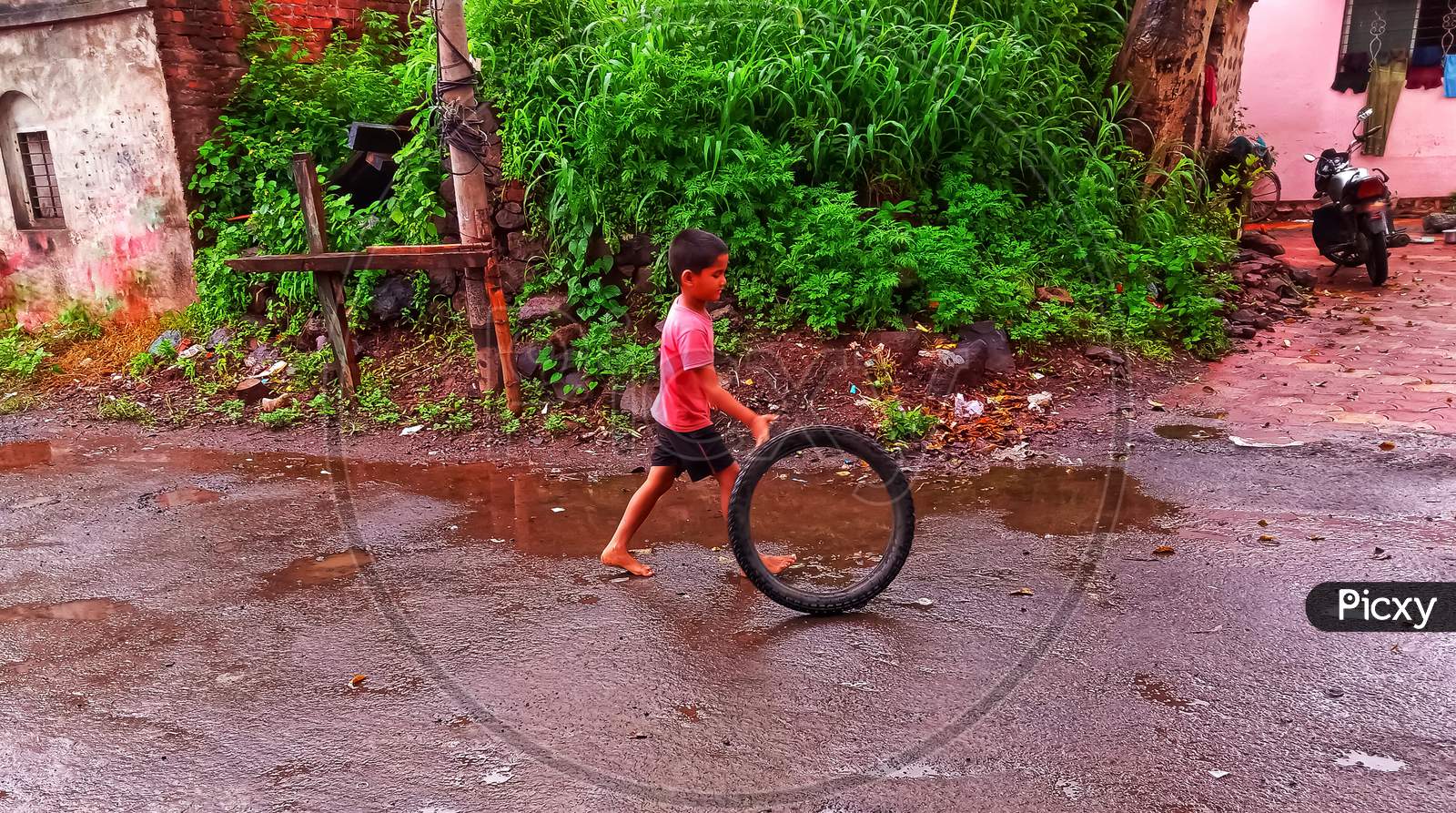 Indian village boy joy in rainy season