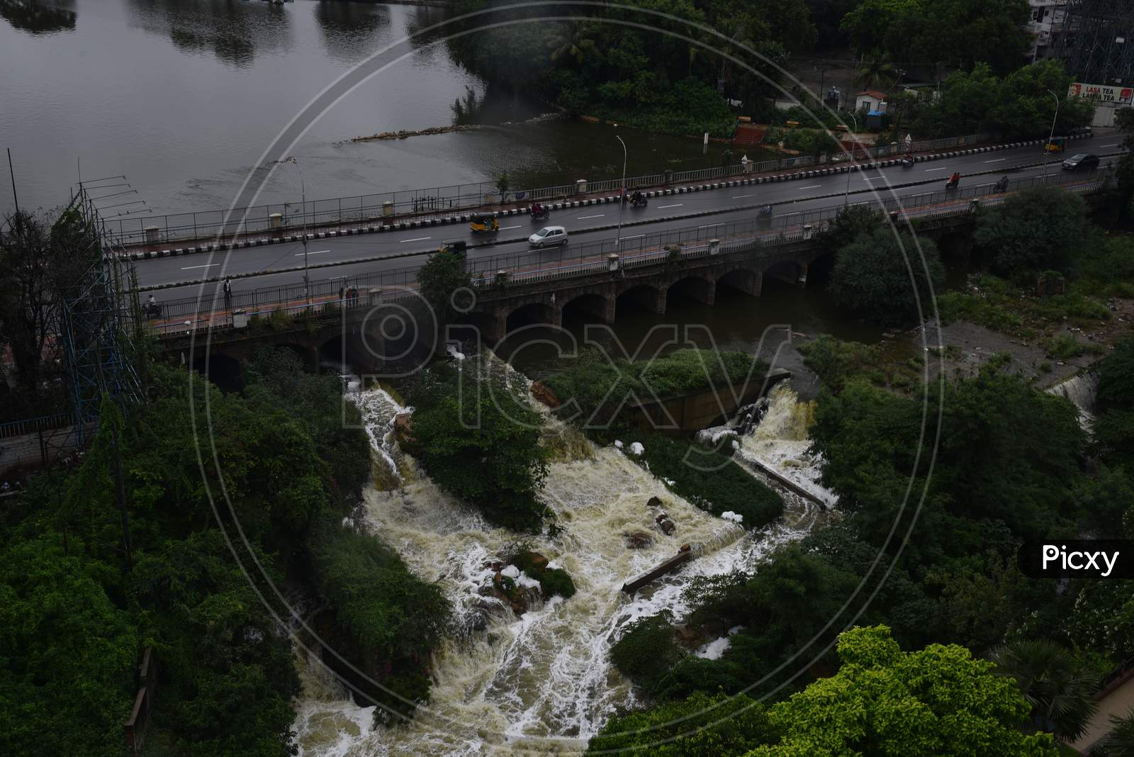 Surplus water from Hussain Sagar of Musi River is being released to downstream as the lake reaches its full capacity of 514metres posing threat to the low lying areas such as Lower Tank Bund and Ashok Nagar, Hyderabad, August 16, 2020