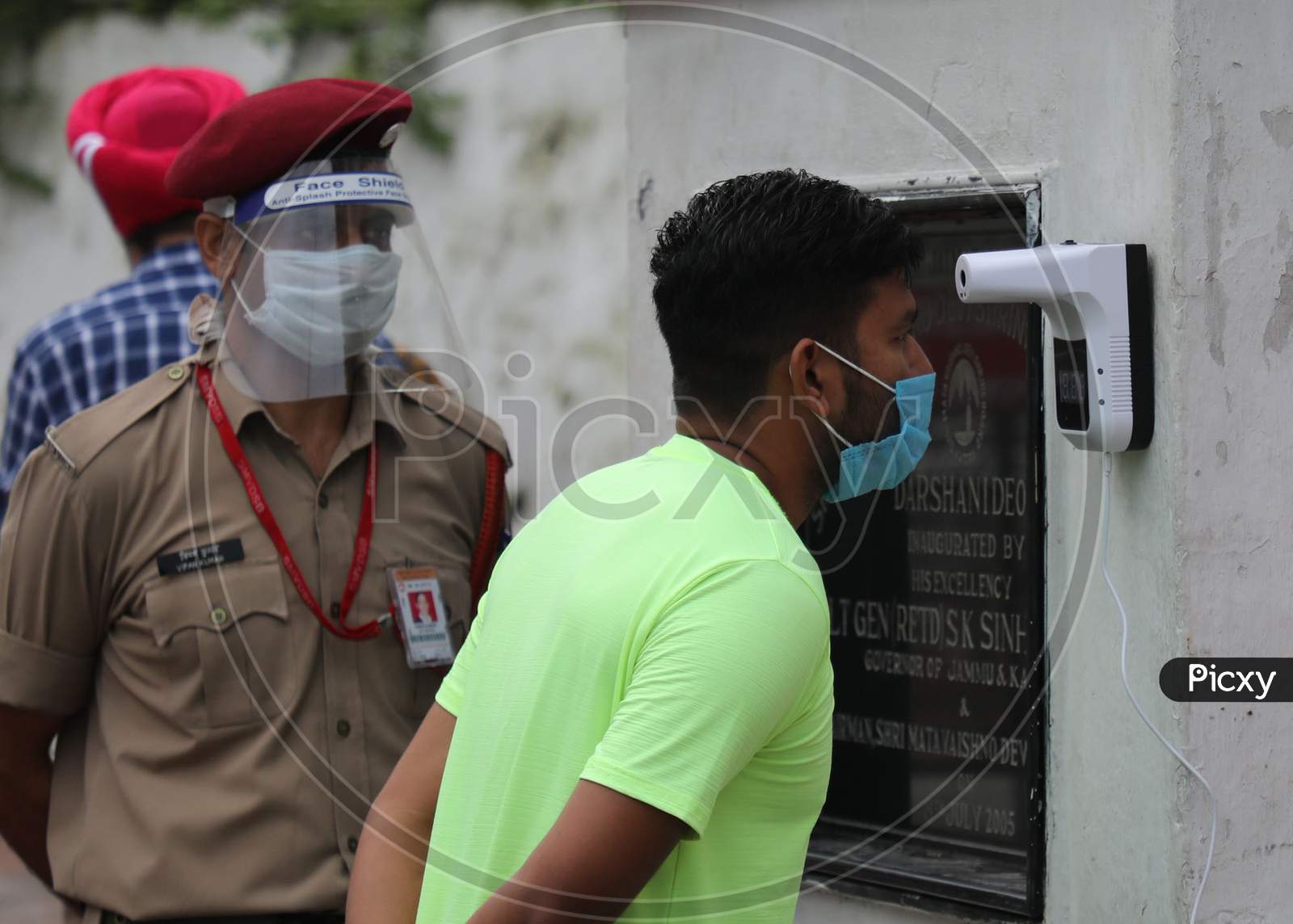 Pilgrims undergo thermal screening at Vaishno Devi  temple after authorities allowed re-opening of religious places in J&K, amid the ongoing COVID-19 pandemic, at Katra in Reasi district,  August. 16, 2020.