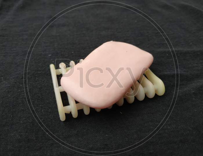 Pink Color Used Soap, Plastic Soap Holder and and Tray isolated on black background