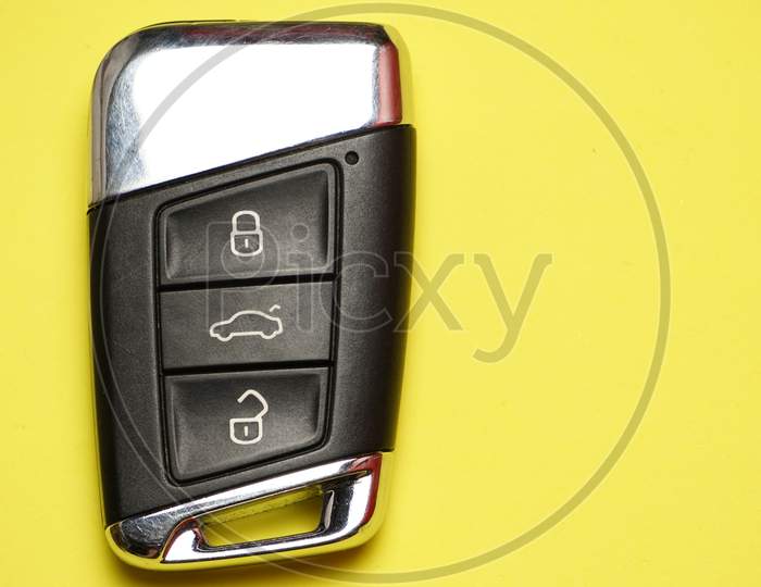 Wireless Car Keys On Yellow Background. Flat Lay Flat Design