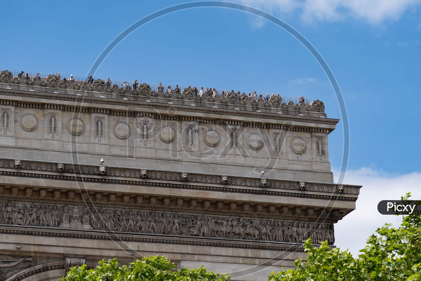 Close-Up Of Arc De Triomphe Covered With Tourists. Paris - France, 31. May 2019