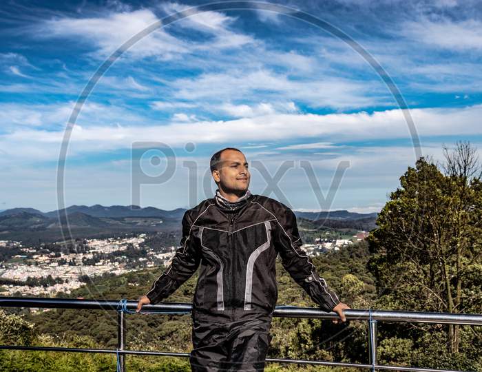 Man Isolated With Amazing Blue Sky And Mountain Range From Hill Top At Day
