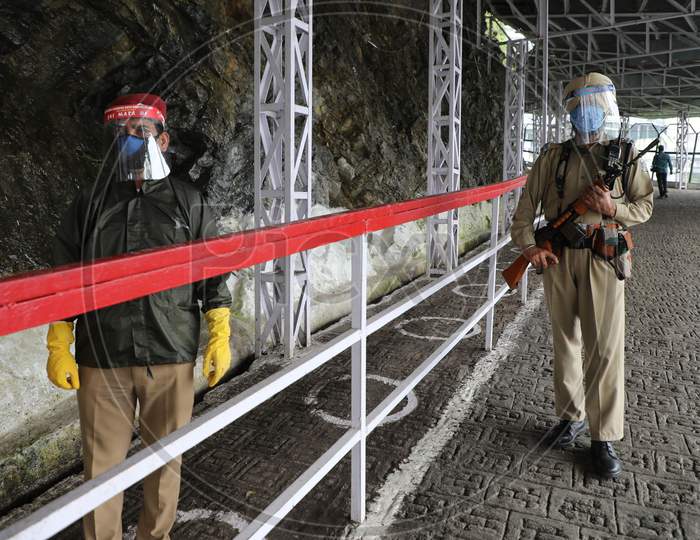 Security personnel wear face shields as they stand outside Vaishno Devi temple after authorities allowed re-opening of religious places in J&K, amid the ongoing COVID-19 pandemic, at Katra in Reasi district, on August 16 2020,