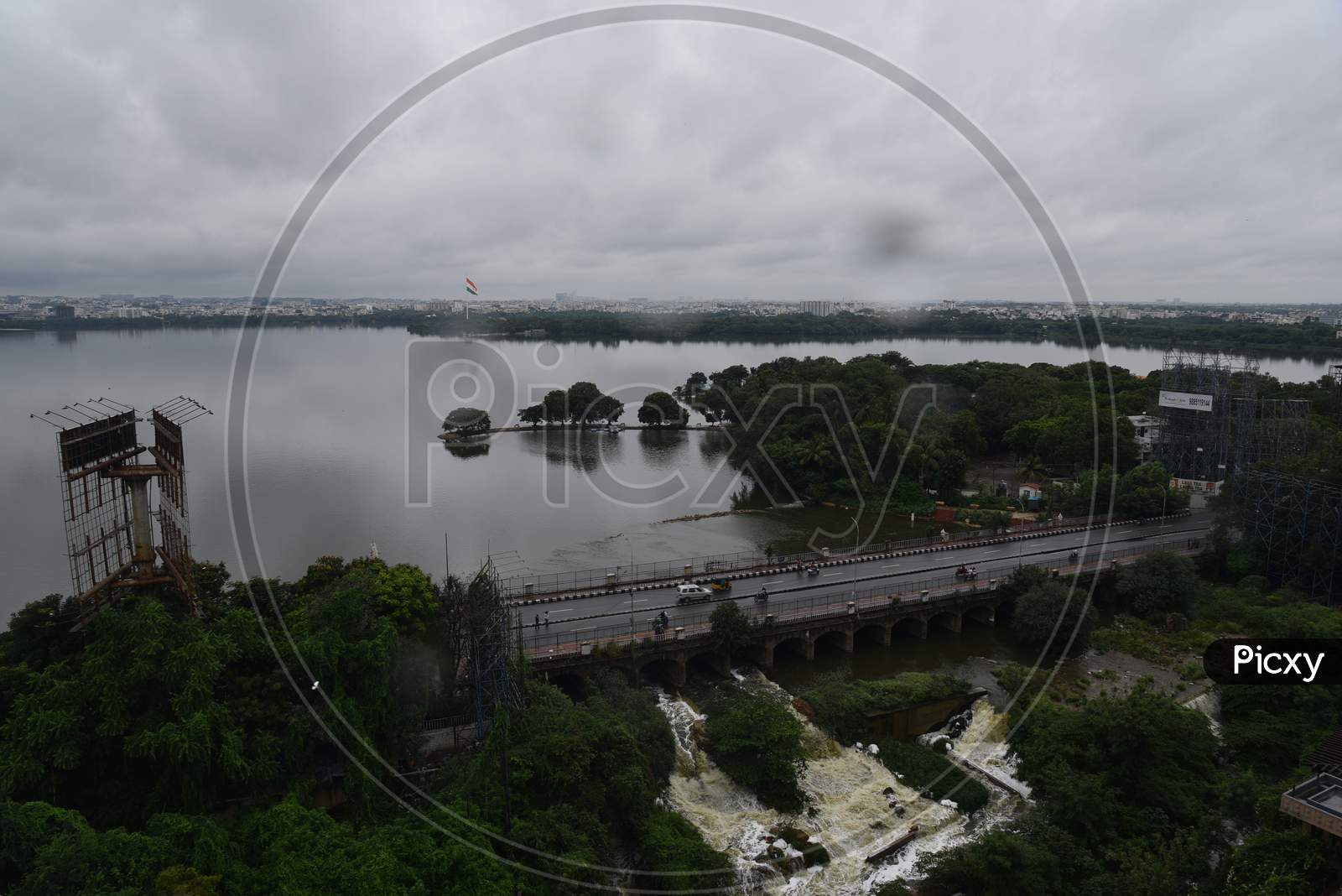 Surplus water from Hussain Sagar of Musi River is being released to downstream as the lake reaches its full capacity of 514metres posing threat to the low lying areas such as Lower Tank Bund and Ashok Nagar, Hyderabad, August 16, 2020