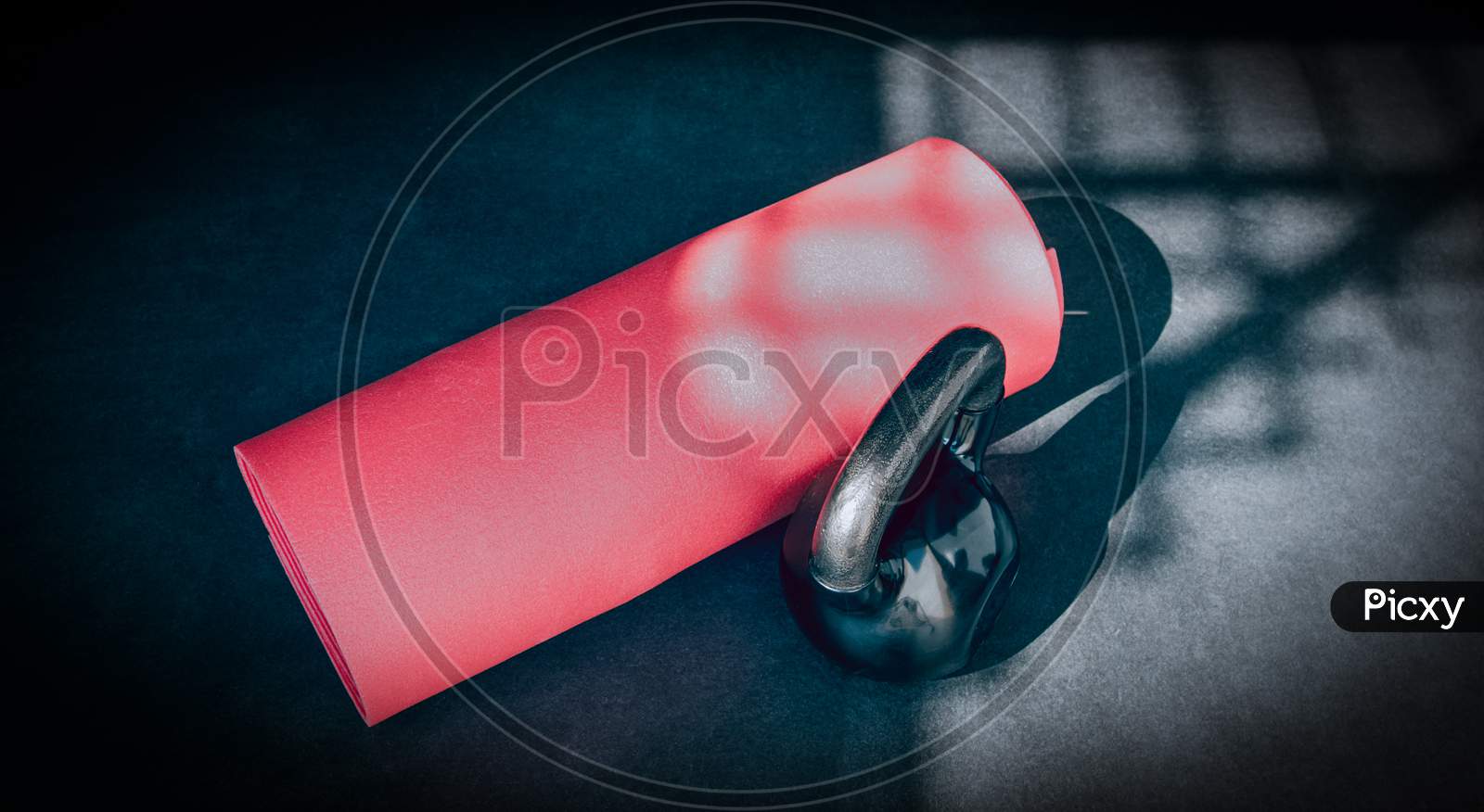 Kettlebell and red gym mat, physical activity and sport