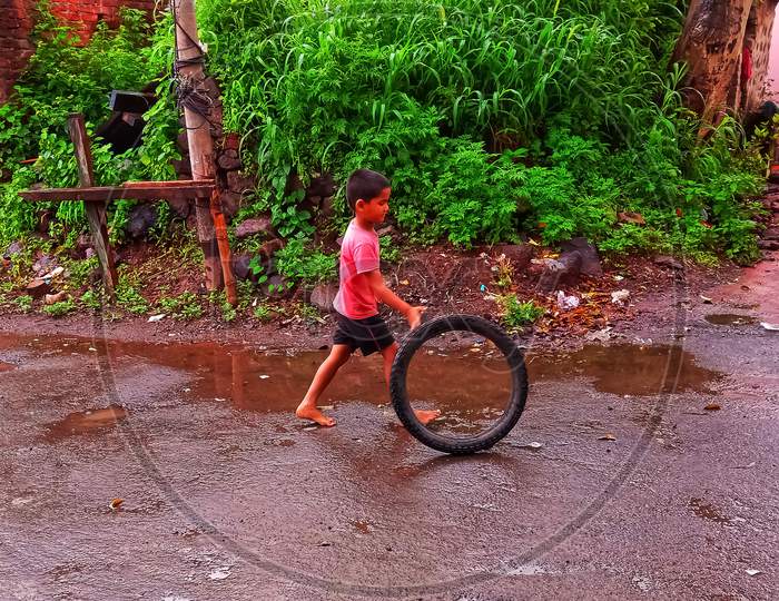 Indian village boy joy in rainy season