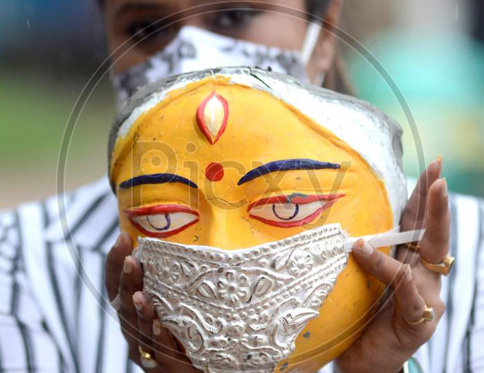 A Puja Committee decorate Silver Face Mask use an idol of goddess Durga being Durga Puja festival, in Kolkata on Monday 17 august 2020