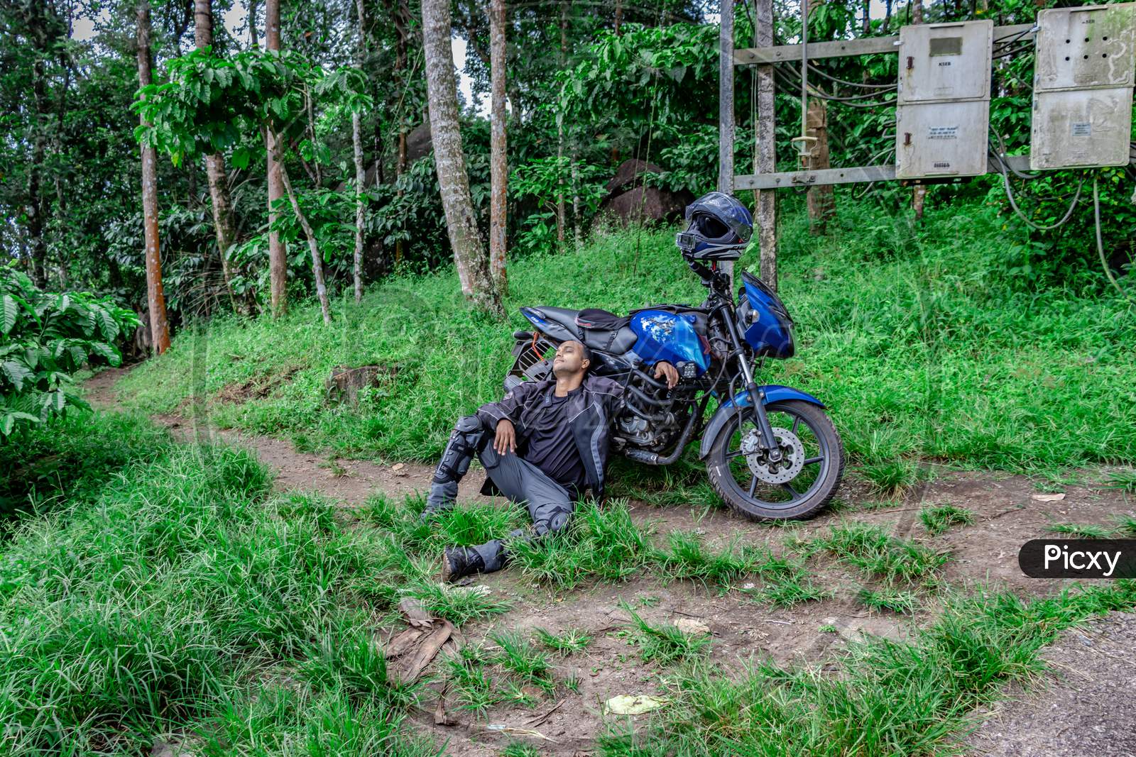 Motorcycle Solo Rider Sitting At Remote Trails With Motorcycle And Helmet