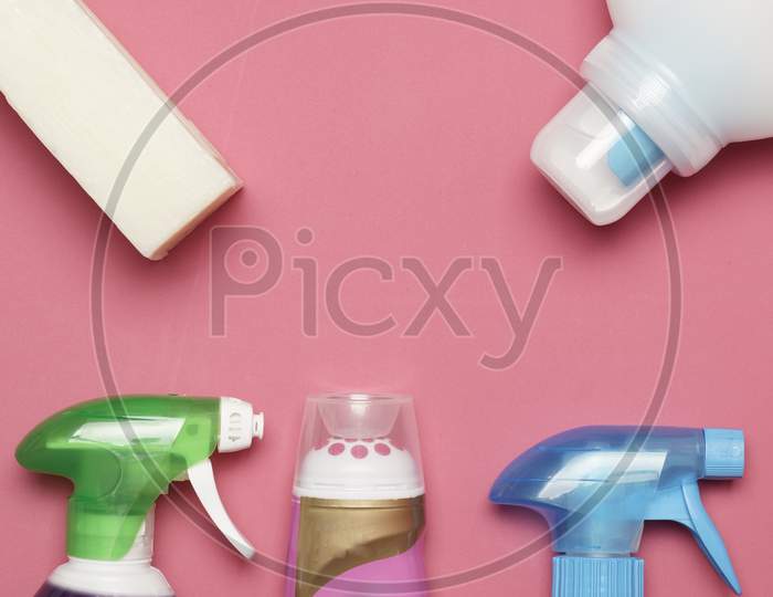 Flat Lay Of Cleaning Products On Pink Background. Home Cleaning Concept