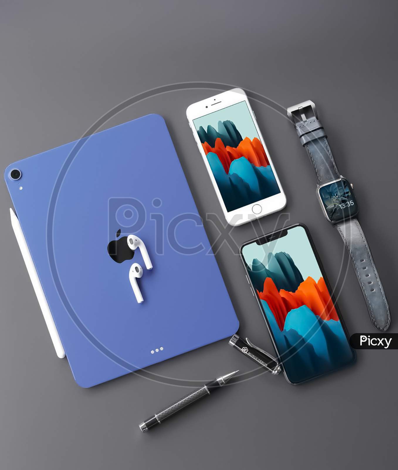 Blue ipad with Phone, watch, pen and ipad.