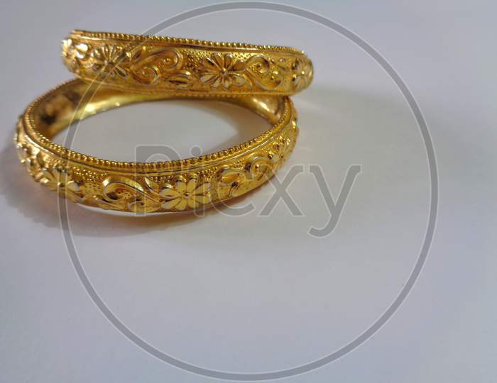 Decorative golden bangle isolated on white background, traditional wedding jewelry for women