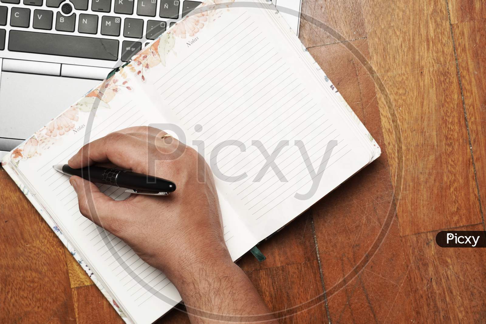 Work Table With Man'S Hand Writing On Agenda With Laptop. Flat Lay. Flat Design