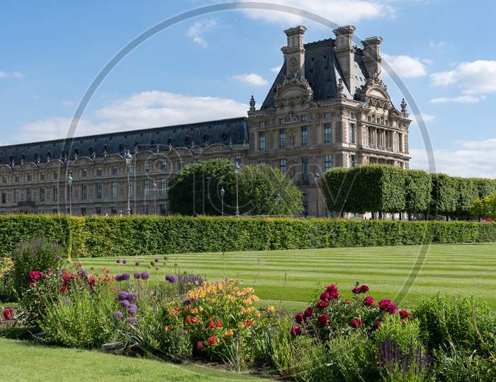 Louvre Palace With Park, Pavillon De Marsan, Lawn And Flowers At Hot Sunny Day. Paris - France, 31. May 2019