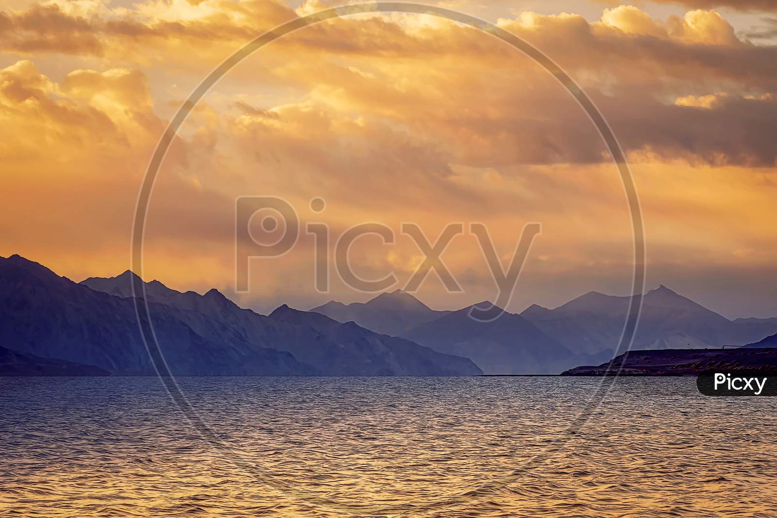 Beautiful Reflations In a Golden Sunrise Over Himalayas Pangong Lake near Leh City