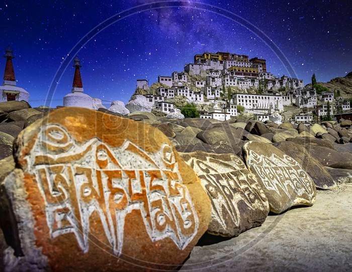 Engraved buddhist chants and text at the Thikse monetary under a starry sky near Leh city, Ladakh, India
