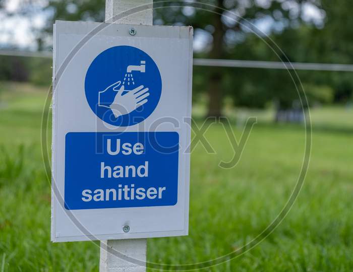 A Sign Asking Visitors To Use Hand Sanitiser At An Outdoor Event As The Coronavirus Lockdown Eases In England