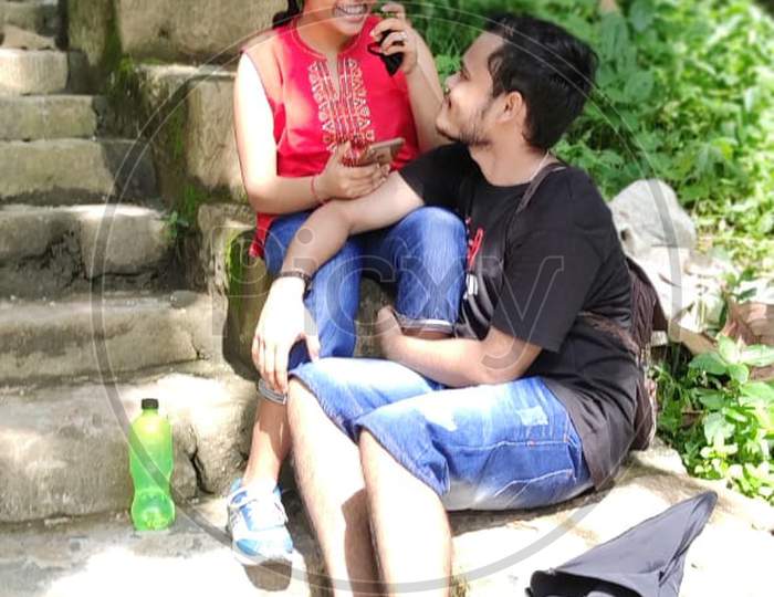 Two young lover sitting valentine day special outdoor romance
