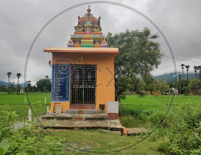 Small Indian temple in agriculture farms in a village