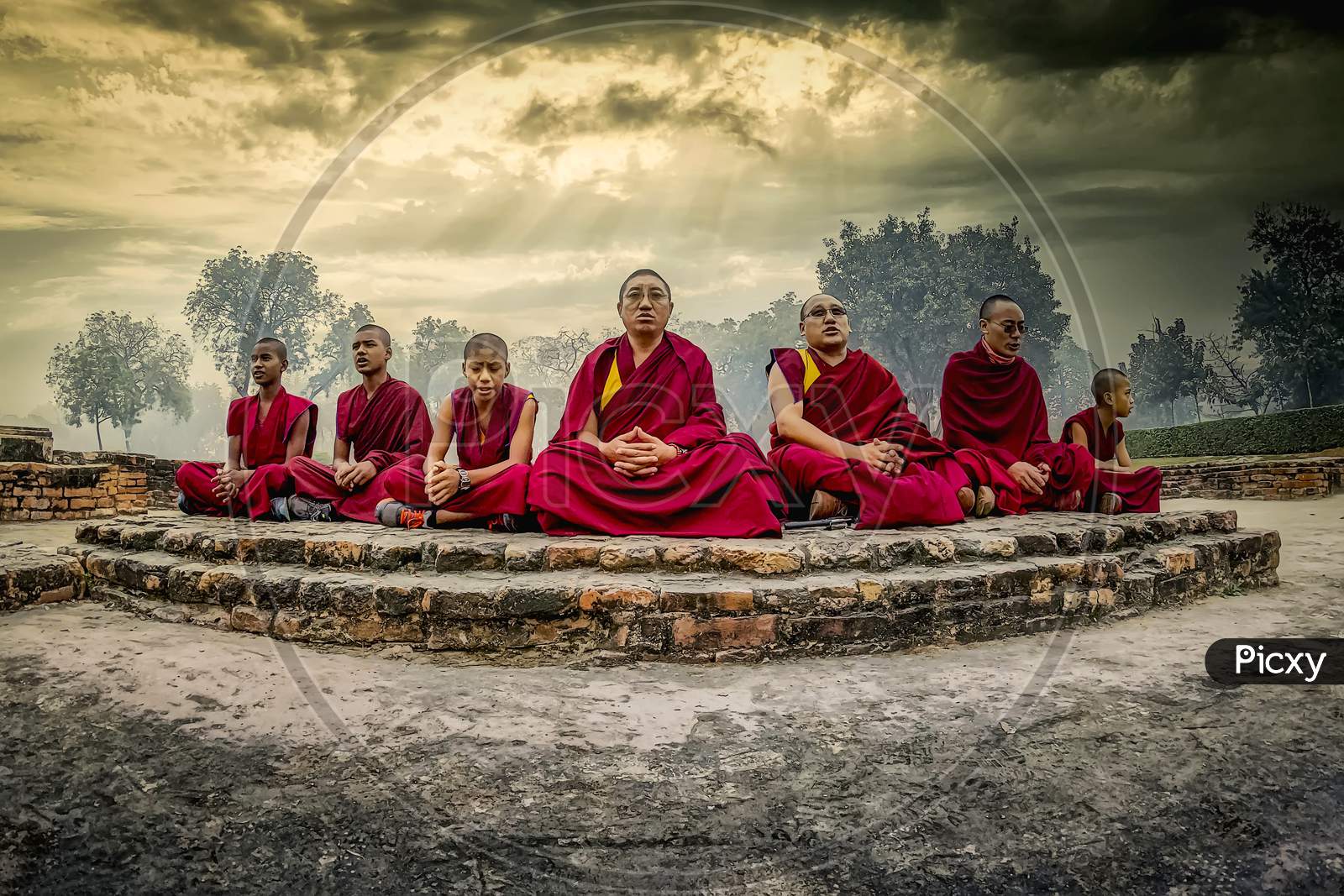 Buddhist monks in meditating at the holy place at the deer park in Sarnath where Gautama Buddha first taught the Dharma, and where the Buddhist Sangha came into existence.