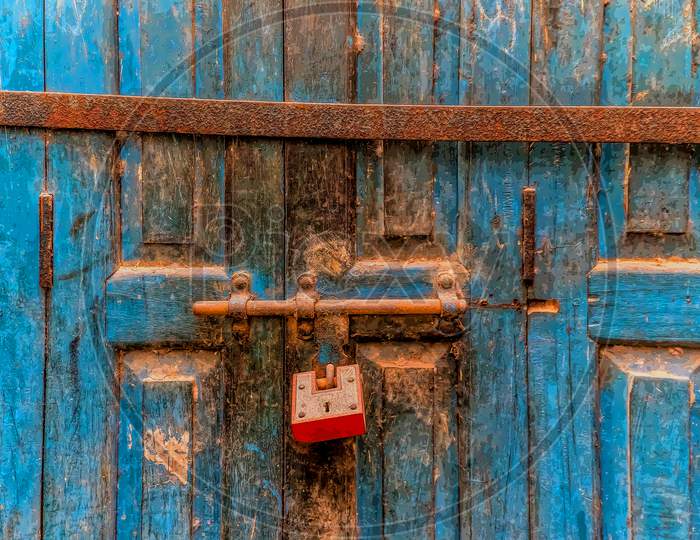 A red rusted lock on an aqua blue wooden door taken during my travels to Varanasi, India