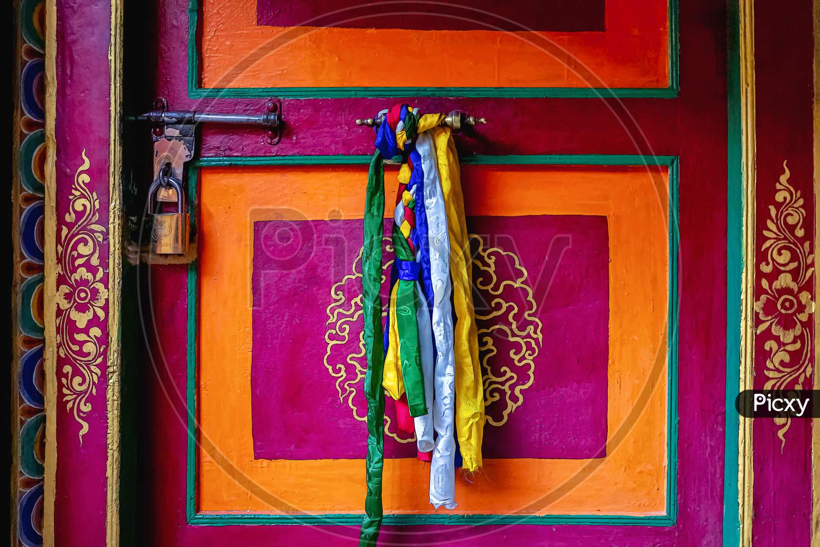 Beautiful colourful doorways with brightly coloured prayer flags decorate the doors of Thiksey Monastery in Ladakh, India