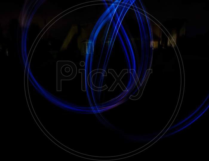 light painting photography, long exposure, ripple circle and waves against black background