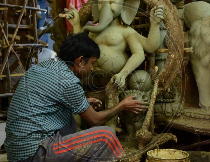 Busy in making Lord Ganesha.