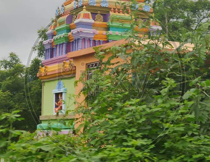 Small colourful Indian temple in agriculture farms in village