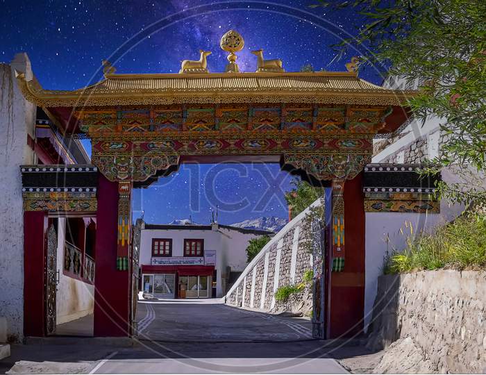 The beautiful decorated gateway arch to the Thikse Gompa under a starry night in Leh, Ladakh, India