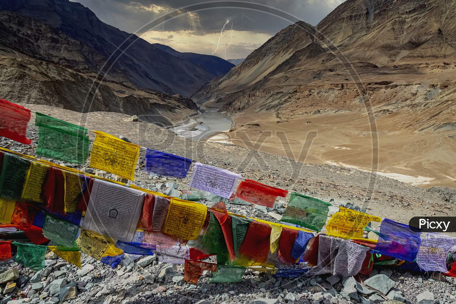 Colourful traditional prayer flags with woodblock-printed text and images brighten up the Himalayan country side in Leh, India .