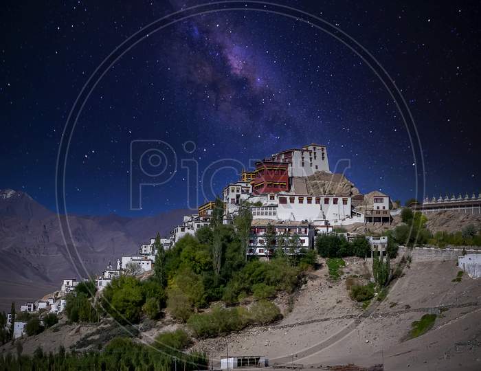 White painted buddhist homes and the holy monetary under a starry sky as seen at the Thikse Monastery village near Leh city, Ladakh, India
