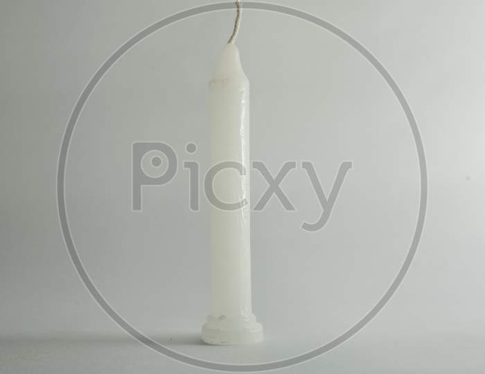 White single candle without burn in clear white background