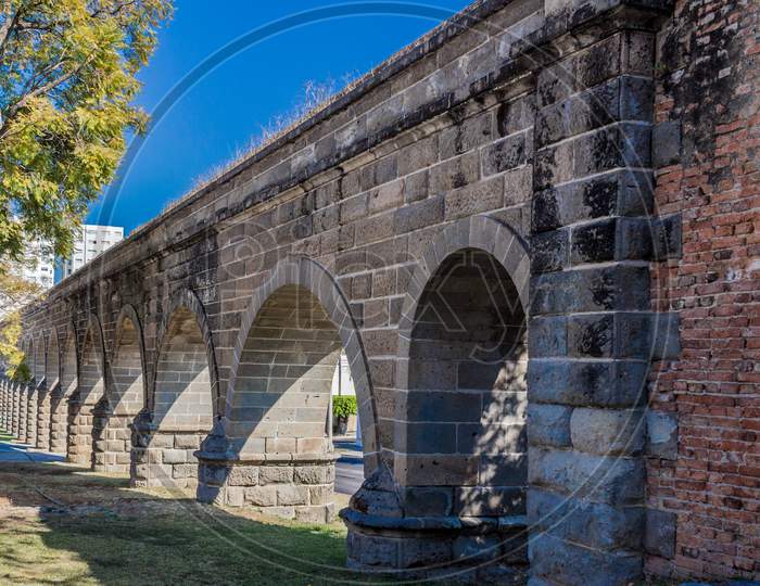 Arches Of A Stone Aqueduct On A Wonderful Sunny Day With A Blue Sky In Guadalajara Jalisco Mexico