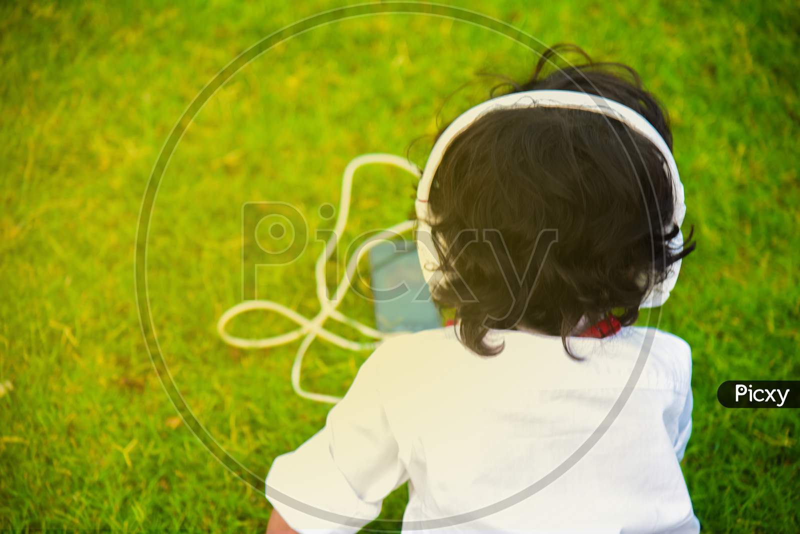 Little Boy Listening Music In Headphones