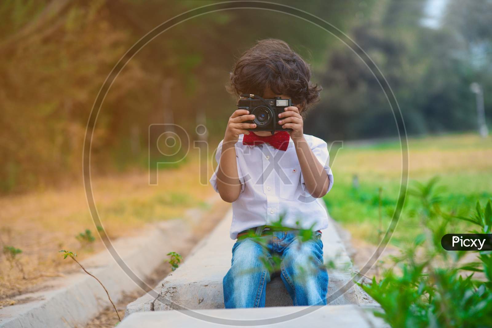 Portrait Of Young Boy Capturing Photo In Old Camera.