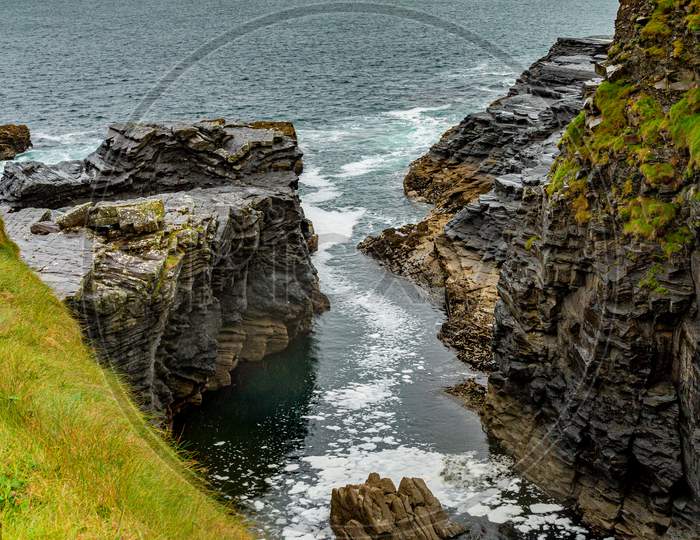 View Of The Water Inlet On A Rocky Cliff In The Coastal Walk Route From Doolin To The Cliffs Of Moher, Geosites And Geopark, Wild Atlantic Way, Rainy Day In County Clare In Ireland
